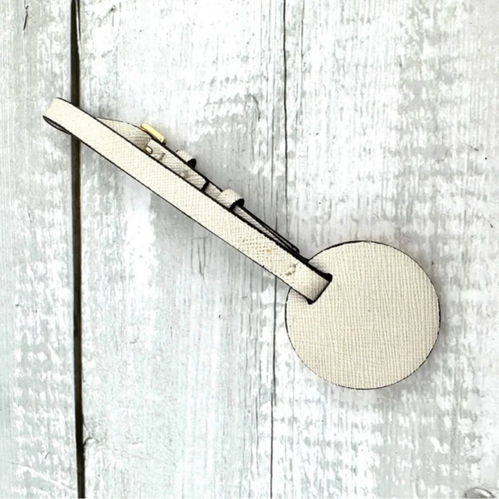 Michael Kors handbag charm.